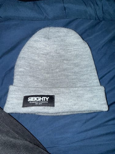 Customer's gray GCS beanie with a black logo patch, shown lying flat.
