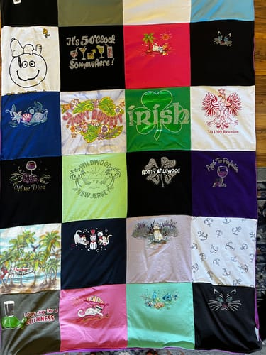 Customer's custom Project Repat T-Shirt Quilt made from colorful t-shirts with various sentimental designs.