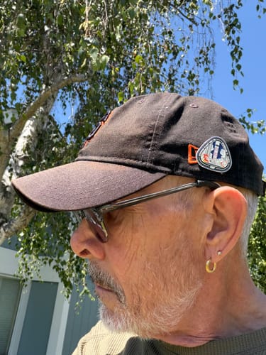 Reviewer showing the Starship Flight 12 Collectors Pin attached to a black baseball cap.