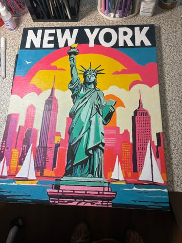 Customer's completed New York Paint by Numbers kit showing a colorful, pop-art style Statue of Liberty and city skyline.