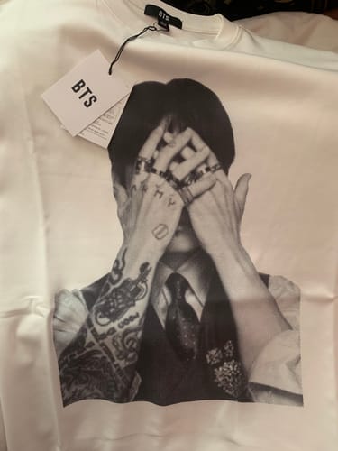 Customer's BTS Arirang T-shirt featuring a black and white print of Jung Kook, with the official tag attached.
