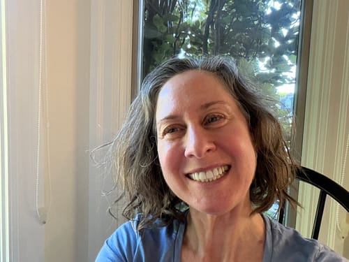 A smiling reviewer showing her face and neck after using the SkinCeuticals Tripeptide-R Neck Repair.