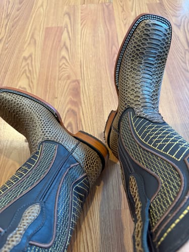Reviewer's view looking down at their Honey Python Leather Boots, showing the detailed stitching and square toe.
