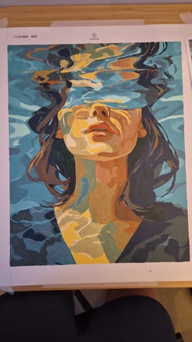 Customer's completed 'Under' Paint by Number project showing a colorful painting of a woman in water.