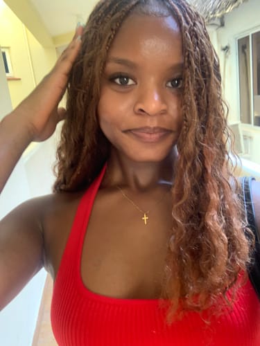 Customer showing off her #30 Light Brown Deep Wave Bulk Hair Extensions styled in braids with curly ends.