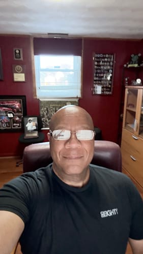 A customer wearing the black 80Eighty® Limited Edition DCG89 Shirt in a close-up photo.