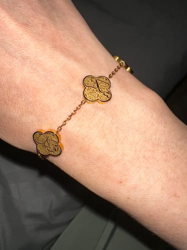 Customer wearing the gold Sabr, Shukr, Tawakkul Bracelet, showing the detailed calligraphy charms on their wrist.