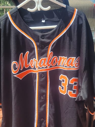 Reviewer's custom black baseball jersey with 'Meralomas' and the number '33' in orange and white lettering.