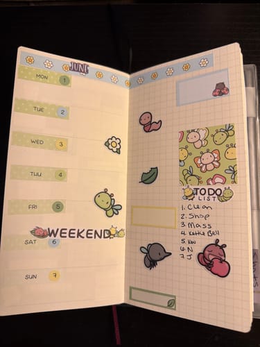 Reviewer's Cute Critters planner open to a weekly spread decorated with cute bug stickers and a to-do list.