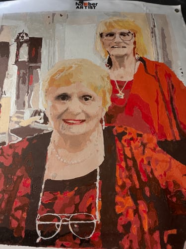 Customer's finished Custom Paint by Numbers Kit, showing a colorful portrait of two women.