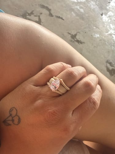 Reviewer's hand wearing the pear-cut CZ silicone ring set, showing the main ring and two stackable bands.