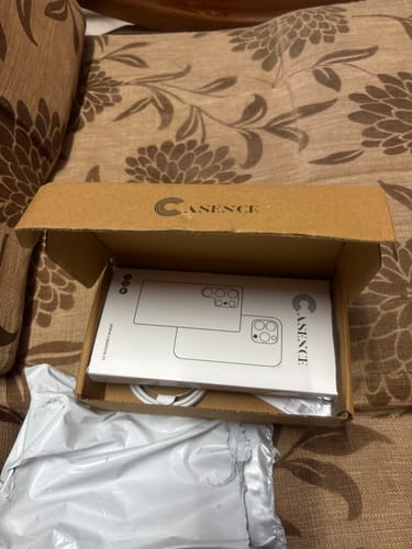 Customer's open delivery box showing the packaging for the Anti Yellow Magsafe Clear Case.