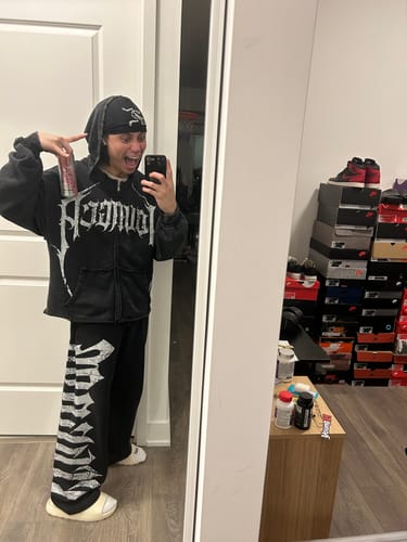 Reviewer taking a mirror selfie wearing the oversized, washed Hardstyle Zip-Up hoodie.
