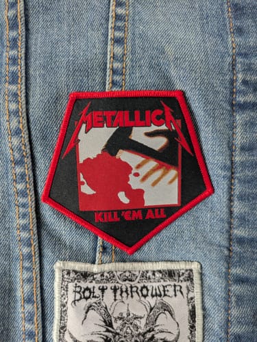 Customer's Metallica - Kill 'Em All patch with a red border sewn onto the back of a blue denim vest.