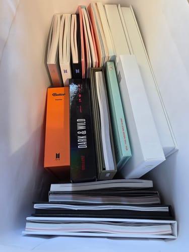 Customer's BTS 10 Years Album Collection, with numerous albums neatly arranged in a box.
