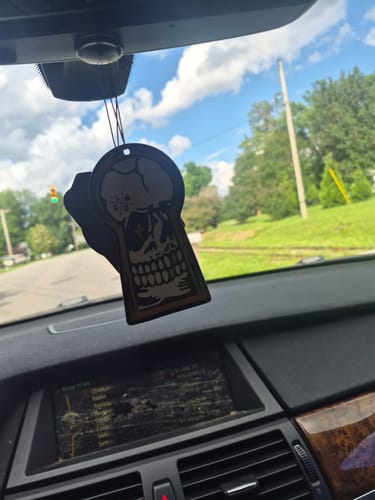 Customer's Lucky Angel Air Freshener with a skull design hanging from the rearview mirror of a car.