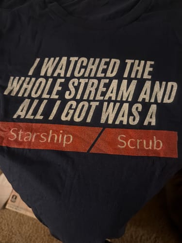 Close-up of the reviewer's Starship Scrub T-shirt, highlighting the blurry and faded graphic.