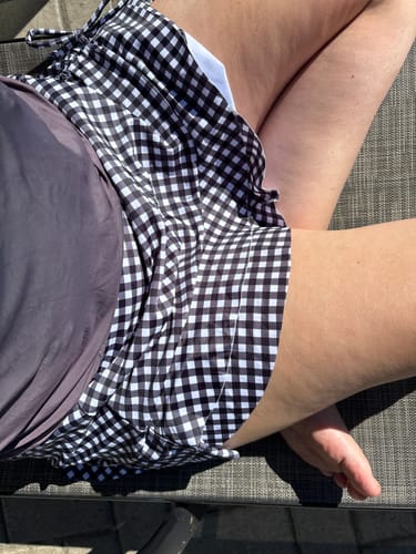 Customer wearing the dark tankini top and the black and white plaid skirt from the 1950s Tankini Set.