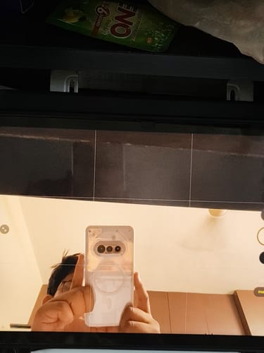 Customer taking a mirror selfie showing their Nothing phone in the clear Anti Yellow Magsafe Case.
