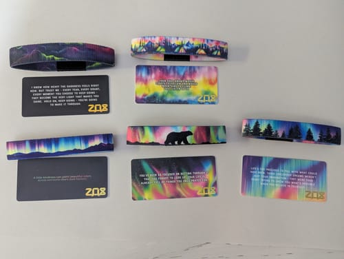 Customer's Aurora Pack with four aurora-themed bracelets and matching cards laid out.