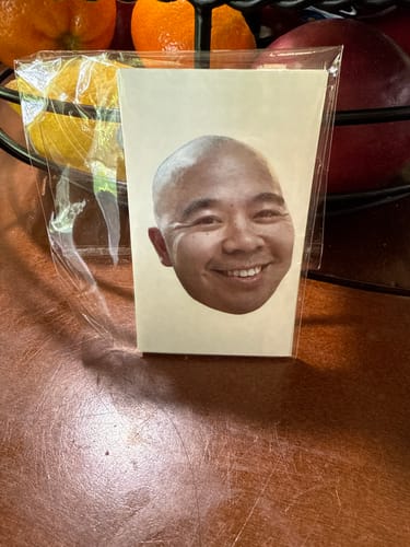 Customer's Custom Photo Face Temporary Tattoo in clear plastic packaging.