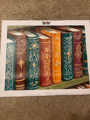Customer's completed Ancient Books paint-by-numbers canvas showing ornate, colorful books on a shelf.
