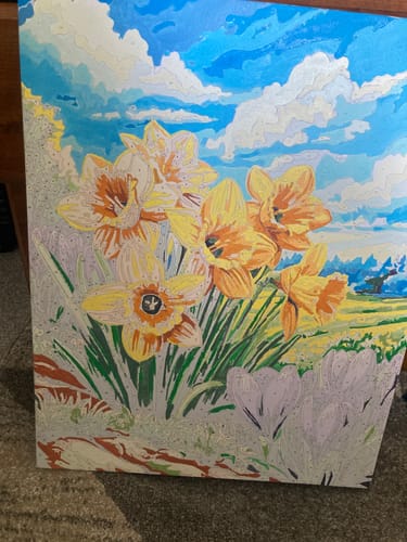Customer's in-progress Yellow Daffodils paint-by-numbers canvas, showing partially colored flowers and sky.