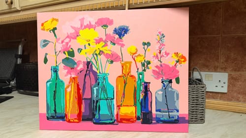 Customer's completed Paint by Number canvas showing colorful flowers in different bright vases against a pink background.