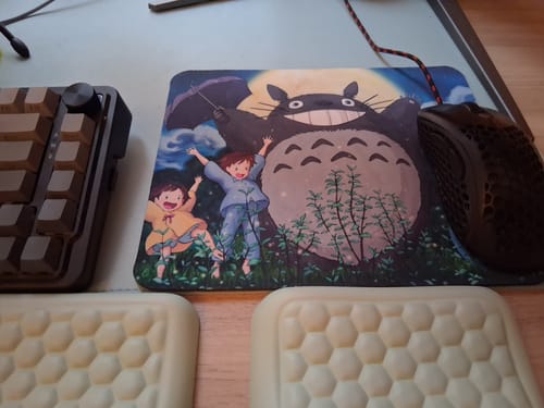 Customer's My Neighbor Totoro Mouse Pad with character art, shown on a desk next to a keyboard and mouse.