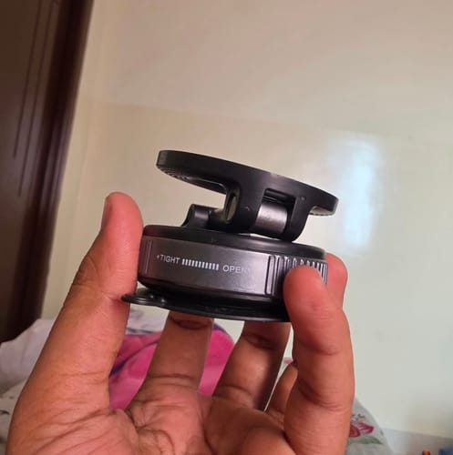 Close-up of a customer holding the suction base of the 360° MagPro Magnetic Phone Holder.