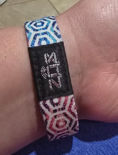 Close-up of a customer's You Are Enough Bracelet, showing the colorful geometric pattern on their wrist.