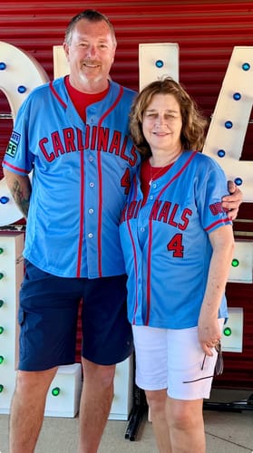 Customers smiling in their matching light blue baseball jerseys with red "Cardinals" text on the front.