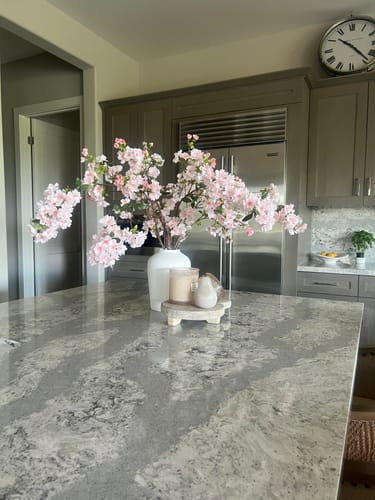 Customer's Faux Japanese Cherry Blossom stems in a white vase on a kitchen island.