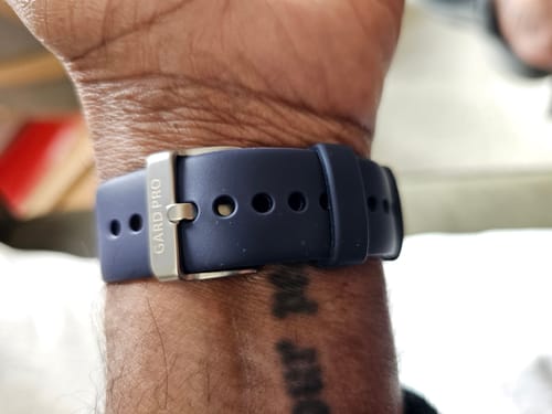 Close-up of a reviewer wearing the dark blue Health Series strap on their wrist.