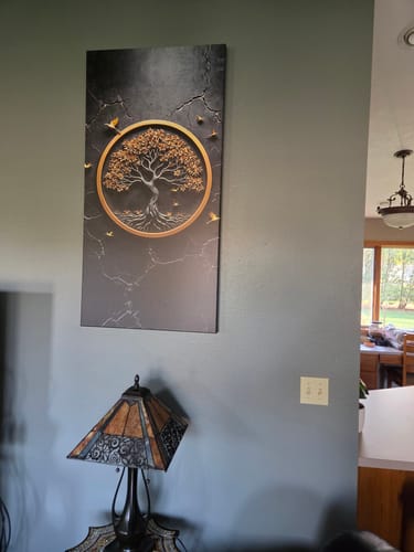 Customer's 3D Celtic Tree of Life Wall Art hanging vertically on a living room wall above a lamp.