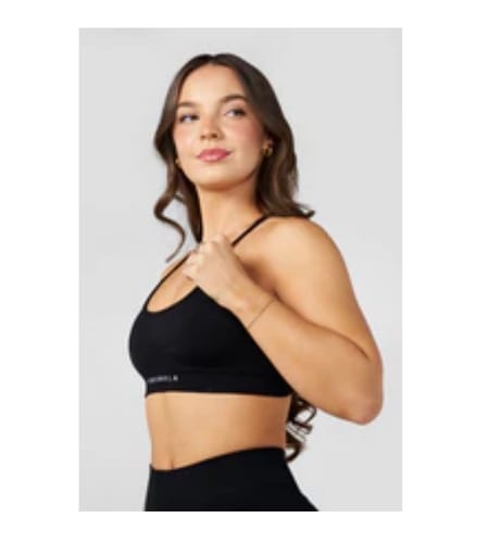 Reviewer wearing the black W338 Curve Seamless Bra, showing a side view of the fit.