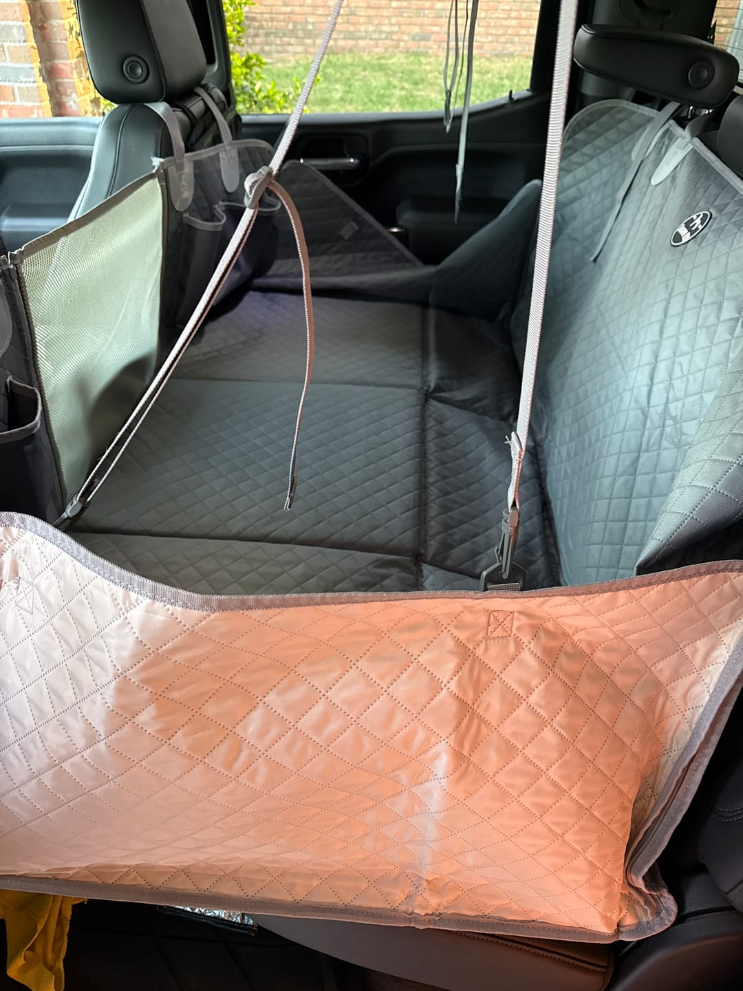 Customer photo review of NEW Waterproof Hard Bottom Car & Truck Seat Foldable Hammock Cover With Storage Pockets, Side Flaps, Headrest Straps, Seat Anchors, & Mesh Window (+FREE SAFETY BELT!)