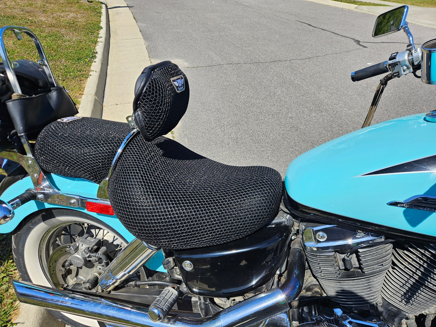 Gel seat cover for motorcycle installed on a Harley Road Glide parked outside a motel in summer rally season