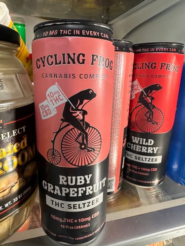 Customer's Ruby Grapefruit and Wild Cherry THC Seltzers from the Variety Pack inside a refrigerator.