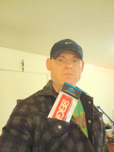 Reviewer with the 80Eighty Smoke Ice Air Freshener pack tucked into a shirt pocket.