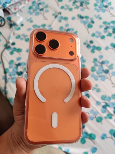 Customer holding their phone with the Anti Yellow Magsafe Clear Case, showing the back with its white MagSafe ring.
