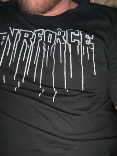 Customer showing a close-up of the black Drip Tee with its white drip design.
