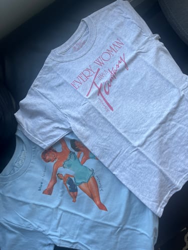 Customer's blue is for boys baby tee laid out flat next to a second grey graphic tee.