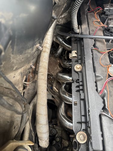 Reviewer's close-up of the shiny, new Long Tube Exhaust Headers installed in their BMW engine bay.