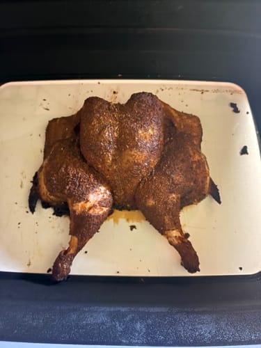 Reviewer's smoked beer can chicken coated in a dark, rich seasoning from the Kosmos Q box.