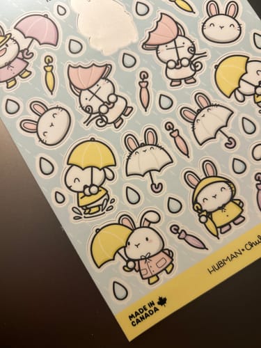 Reviewer's sheet of Rainy Day Bunnies stickers, showing adorable bunnies in yellow raincoats and holding umbrellas.