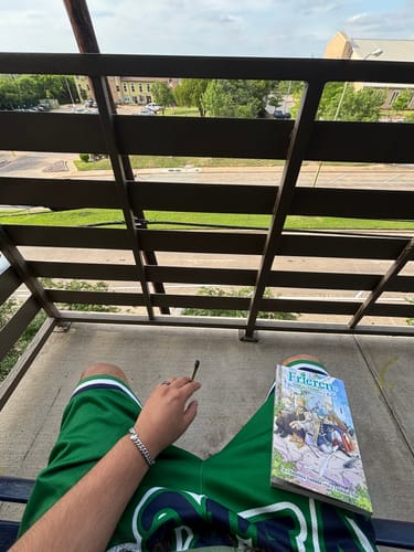 Customer relaxing on a balcony while wearing the silver-toned Evil Eye Bracelet on their wrist.