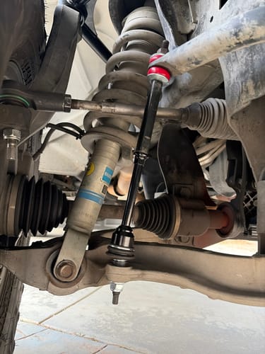 Customer's KSP Sway Bar Link installed on a truck, showing the black bar and red polyurethane bushing.