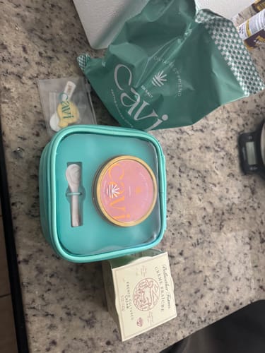 Reviewer's bag of CAVI's Kettle Cooked Sea Salt Chips shown with a caviar kit on a countertop.