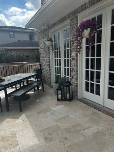 Customer's beautiful, realistic Outdoor Hanging Petunia Basket hanging on a patio.